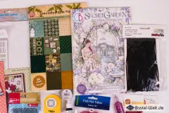 Detailausschnitt mit Craft-Perfect-Spiegelkarton, Cart-Us-Winter-Spezialpapierpack und schwarzem Velourband von HobbyFun.